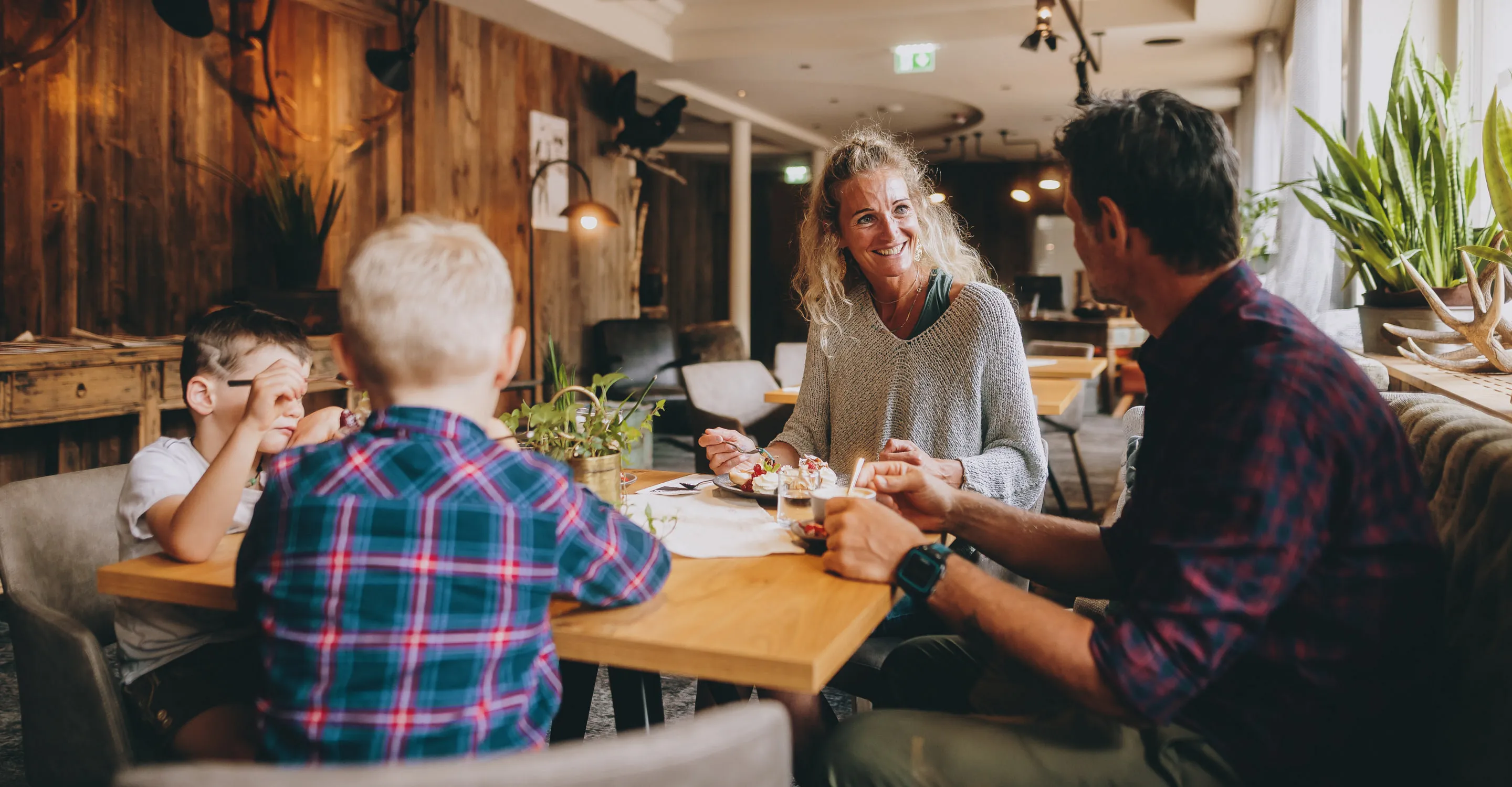 Gruppe von Menschen, die in einem gemütlichen Restaurant essen und lächeln